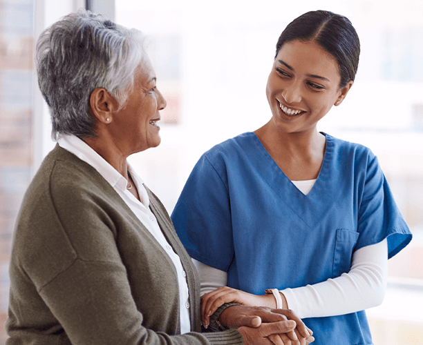 Healthcare professional assisting an elderly patient