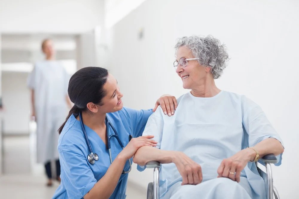 Healthcare worker assisting an elderly man